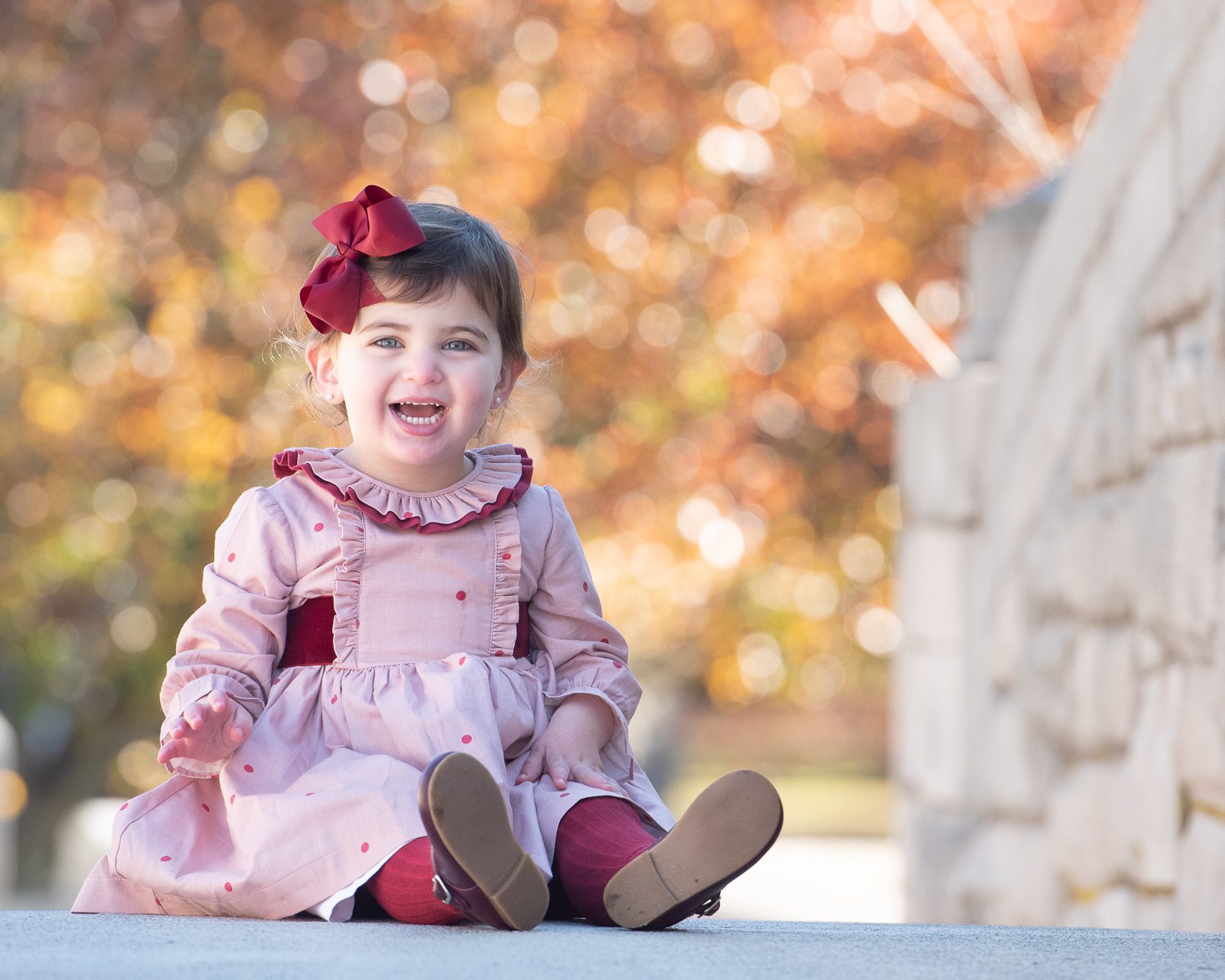Little Girl in Red Dress in Bow on Bridge in Verona Park NJ